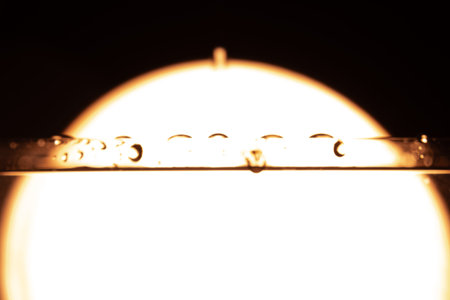 330.Water Droplets on Tube with Backlit Halo Effect