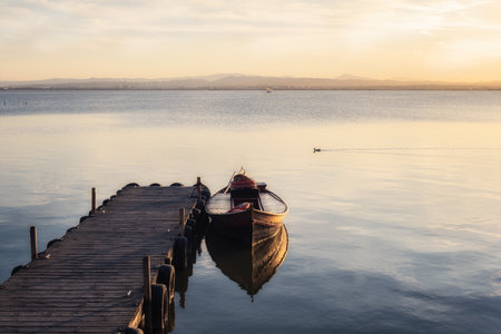 Fishing Boat Moored to a Pier at Sunset, Lagoon Valenciaの写真素材