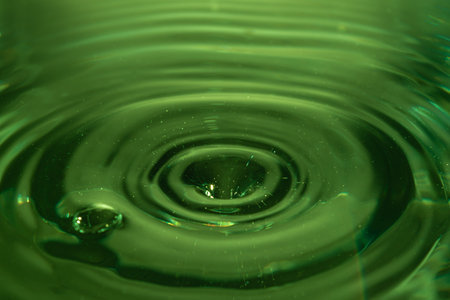 321.Green Liquid Ripple from Droplet Impact Centerの写真素材