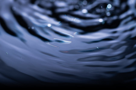 281.Dark Blue Water Ripples with Droplets and Reflectionsの写真素材