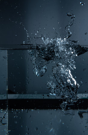 10.Ice Cubes Dropped into Water with Splash and Bubblesの写真素材