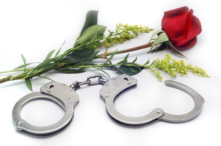Handcuffs and Rose in white background.の写真素材