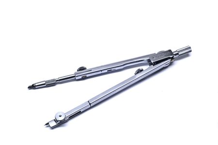 Stainless steel drawing compass in white background.の写真素材