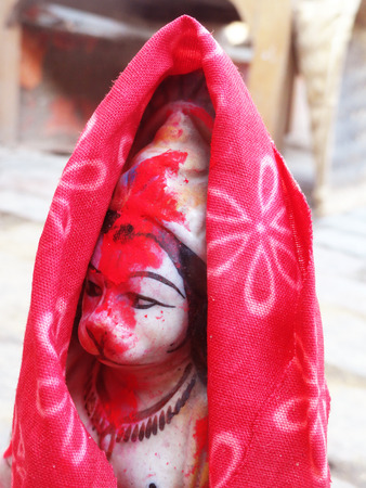 God Hanuman idol with red cloth covered and red lead on face.の写真素材