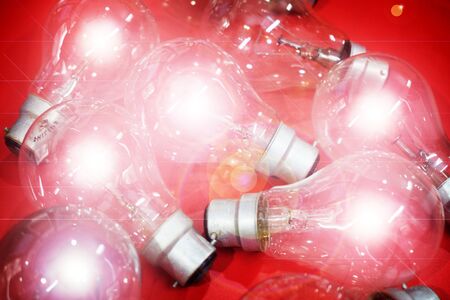 Glowing Light Bulb isolated on Red Backgroundの写真素材