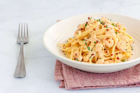 Creamy Shrimp / Prawn Pasta Garnished with Basil and Chili Peppers Close Up Photoの写真素材