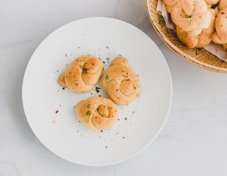 Fresh Garlic Knots in a Dish and Basket Directly Above Photoの写真素材