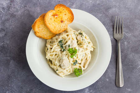 Creamy Spaghetti Pasta with Chicken Garnished with Fresh Parsleyの写真素材