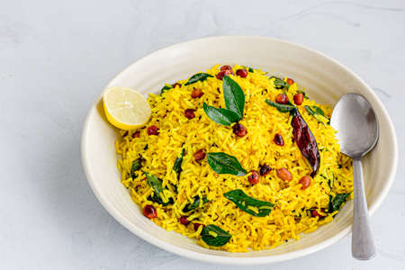 South Indian Vegetarian Dish of Rice, Lemon and Peanuts Garnished with Curry Leavesの写真素材