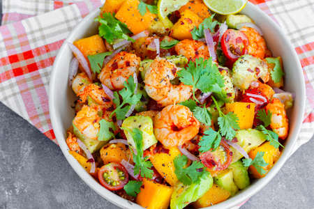 Healthy Shrimp Mango Salad with Avocado, Cherry Tomatoes and Onion, Garnished with Fresh Cilantroの写真素材
