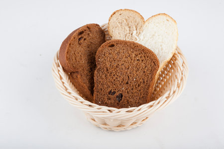 two varieties of black and white bread in a basket