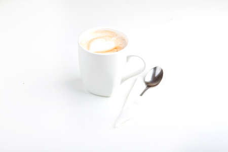 morning delicious cappuccino in a large white cup on a white backgroundの写真素材