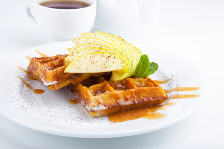 delicious sweet dessert on white plate with teaの写真素材