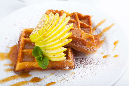 delicious sweet dessert on white plate with teaの写真素材