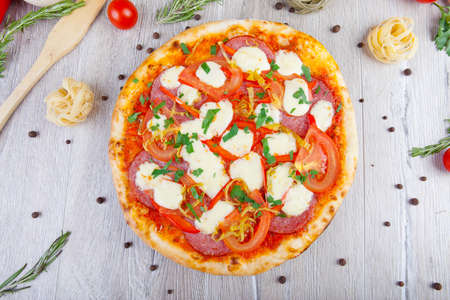 italian pizza on a wooden background with decoration aroundの写真素材