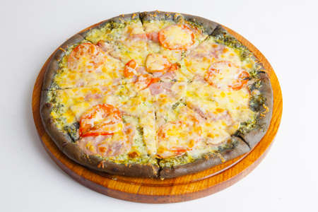 italian pizza with black dough on wooden boardの写真素材