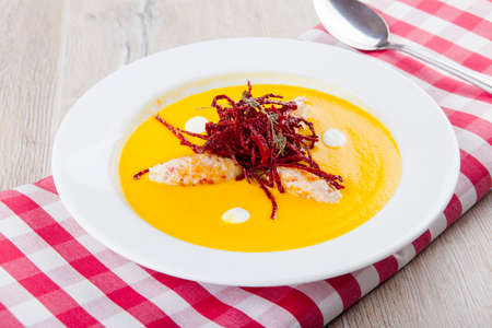 pumpkin soup with chicken cutlets and beet friesの写真素材