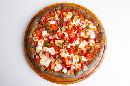 italian pizza with black dough on wooden boardの写真素材