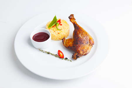 BBQ duck leg with rice and red sauceの写真素材