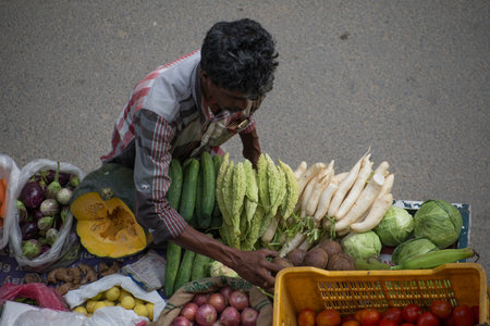 Bangalore, India, August, 2014 : street vendor selling vegetables in Bangalore India