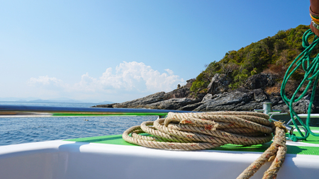 Bow of a boat The metal rim glitters. It offers a lot of green stones. White clouds with sky.の写真素材