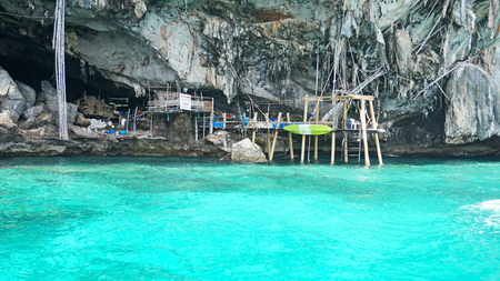 Sheer cliffs, blue water and a Viking cave. Phi Phi Islands, Thailand. See the stalactites, and built of bamboo. The turquoise color of the water. Unusual landscape. The stones of the deserted islandのeditorial素材