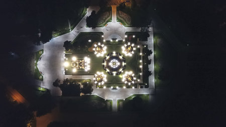 Bright Church with golden domes and crosses. Glows in the night Park. Drone footage. Top and side...