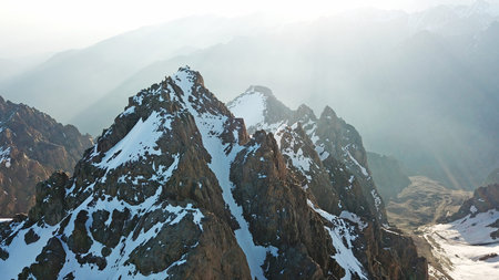 View of the snowy peaks from the drone. Highest peak. You can see huge rocks, cliffs, avalanches,...