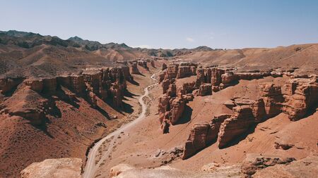 Charyn canyon is the younger brother of the Grand canyon in the United States. Located in Kazakhstan. Visible layers of earth rock, huge crevices, hills and a degree. Red color of breed. Like Mars.の写真素材