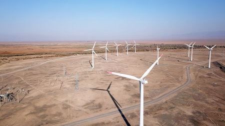 Windmills in the steppe. Near a small town. Alternative, clean energy. Top view from the drone on...