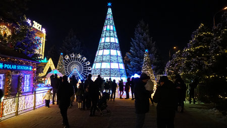 The city is decorated for Christmas and new year. Buildings, garlands, Christmas trees, fences and the square glow with different lights. People relax, enjoy the winter and holiday. Almaty, Kazakhstanのeditorial素材