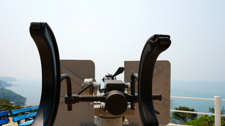 Observation deck with a military cannon. Machine gun on the shore. Protecting the island. Military weapons, army. History of the battle. A large caliber. Memory of the battle. Chang Island, Thailand.の写真素材