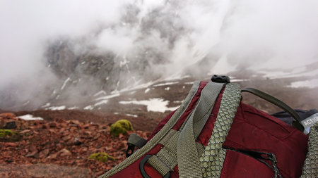 Backpack in the snowy mountains. Fog is coming.の写真素材