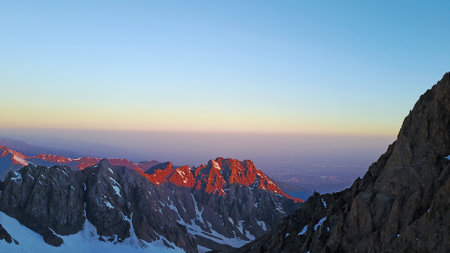 Epic red dawn on top of snowy mountains.の写真素材
