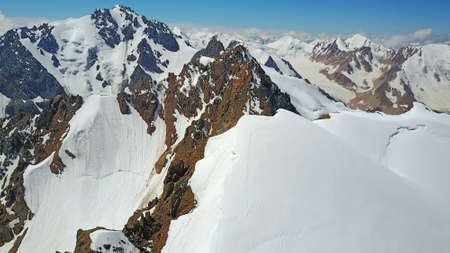 Huge snow mountains. View from a drone.の写真素材