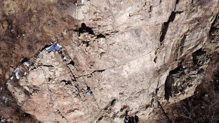A group of people are engaged in rock climbing.の写真素材