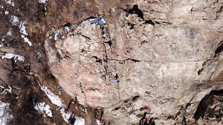 A group of people are engaged in rock climbing.の写真素材