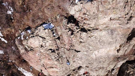 A group of people are engaged in rock climbing.の写真素材