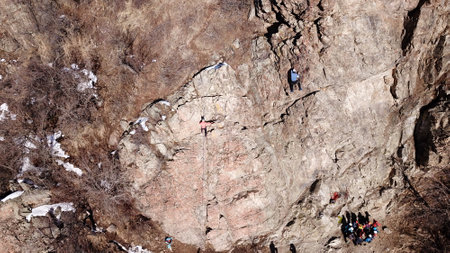 A group of people are engaged in rock climbing.の写真素材