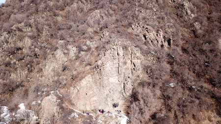 A group of people are engaged in rock climbing.の写真素材