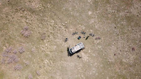 A car in a field with bicycles Top view from droneの写真素材