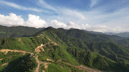 Green hills and mountains with white clouds.の写真素材