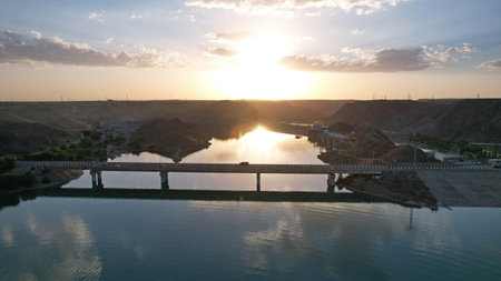 Sunset with a view of the dam and bridge.の写真素材
