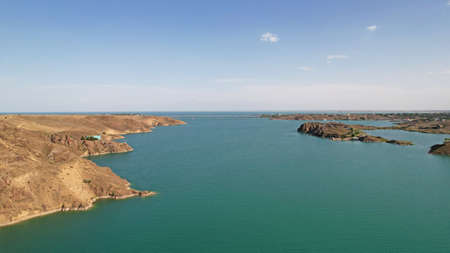 Flying over a lake with islands and rocks.の写真素材