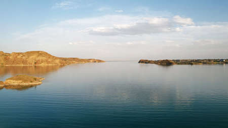 Flying over a lake with islands and rocks.の写真素材