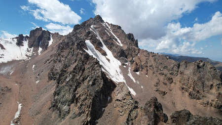 High rocky mountains covered with ice in places.の写真素材