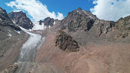 High rocky mountains covered with ice in places.の写真素材