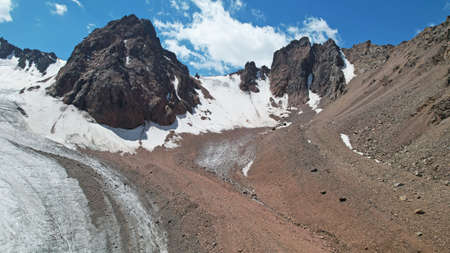 High rocky mountains covered with ice in places.の写真素材