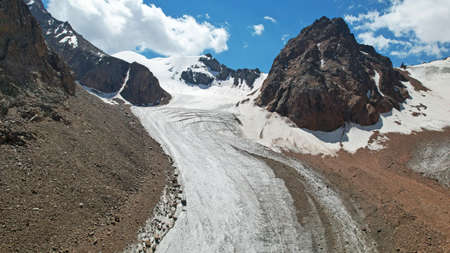 High rocky mountains covered with ice in places.の写真素材