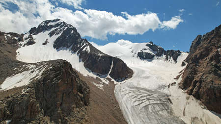 High rocky mountains covered with ice in places.の写真素材